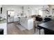 Open floor plan showcasing the kitchen with a center island and stainless steel appliances, seamlessly flowing to the living area at 20 Geranium Ln, Covington, GA 30016