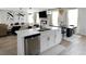 Open-concept kitchen and living area featuring an island, stainless steel appliances, and stylish modern decor at 20 Geranium Ln, Covington, GA 30016