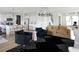 Open-concept living space with kitchen island, barstool seating, and comfortable furniture with a stylish black and white rug at 20 Geranium Ln, Covington, GA 30016