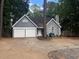 Charming single-Gathering home with a two-car garage and well-maintained lawn at 2032 Hopkins Mill Road, Duluth, GA 30096