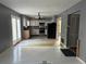 Well-lit kitchen with white cabinets, stainless steel appliances, and access to outdoor patio at 2032 Hopkins Mill Road, Duluth, GA 30096