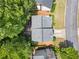 Aerial view of a home showcasing its roof, backyard deck, and proximity to trees at 2967 Albright Cmns, Kennesaw, GA 30144