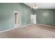 Open bedroom featuring neutral carpet, light green walls, high ceilings, and a ceiling fan at 2967 Albright Cmns, Kennesaw, GA 30144