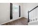 Entryway featuring modern wood flooring, a front door, and adjacent staircase at 2967 Albright Cmns, Kennesaw, GA 30144