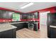 Kitchen area featuring black cabinetry, granite countertops, and stainless steel appliances at 2967 Albright Cmns, Kennesaw, GA 30144
