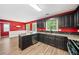 Open kitchen featuring modern appliances, dark cabinets, and lots of counter space at 2967 Albright Cmns, Kennesaw, GA 30144