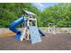 Community playground with a slide, climbing wall, and swings surrounded by mulch at 2967 Albright Cmns, Kennesaw, GA 30144