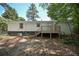 View of the home's backyard, featuring a raised wooden deck and partially fenced yard at 3000 Kennesaw Nw Dr, Kennesaw, GA 30152