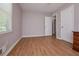 Bedroom with wood-look flooring, neutral walls and ensuite bathroom at 3000 Kennesaw Nw Dr, Kennesaw, GA 30152