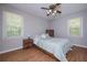 Bedroom featuring wood-look floors, ceiling fan, and two windows at 3000 Kennesaw Nw Dr, Kennesaw, GA 30152