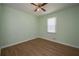 Bedroom featuring wood-look flooring, neutral walls, ceiling fan and window at 3000 Kennesaw Nw Dr, Kennesaw, GA 30152