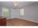 Bright bedroom featuring wood-look floors, ceiling fan and built-in shelving at 3000 Kennesaw Nw Dr, Kennesaw, GA 30152