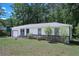 Quaint single-story house with well-maintained lawn, attached garage, and stone facade at 3000 Kennesaw Nw Dr, Kennesaw, GA 30152