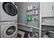 Laundry room featuring stacked washer and dryer and storage at 3000 Kennesaw Nw Dr, Kennesaw, GA 30152