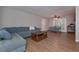 Open-concept living room with hardwood floors, a comfy blue couch and neutral-colored walls at 3000 Kennesaw Nw Dr, Kennesaw, GA 30152
