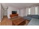 Inviting living room with hardwood floors, a large flat screen TV, gray walls and plenty of natural light at 3000 Kennesaw Nw Dr, Kennesaw, GA 30152