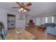 Well-lit living room featuring dining area, TV, hardwood floors, neutral walls and an open layout at 3000 Kennesaw Nw Dr, Kennesaw, GA 30152