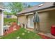 Backyard area highlighting a patio area, stone steps, and a lush, green lawn, offering a private outdoor space at 1020 Regency Dr, Acworth, GA 30102