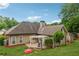Picturesque backyard with a stone patio, pergola, lush lawn, and mature trees, perfect for outdoor relaxation at 1020 Regency Dr, Acworth, GA 30102