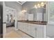 The primary bathroom features a double vanity with marble countertops and is open to the bedroom at 1020 Regency Dr, Acworth, GA 30102