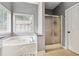 This primary bathroom features a soaking tub, separate shower, linen closet and a window at 1020 Regency Dr, Acworth, GA 30102