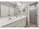 Bathroom showcasing a double sink vanity with a large mirror and white cabinets at 1020 Regency Dr, Acworth, GA 30102