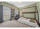 Serene bedroom featuring a cozy floor bed, a comfortable gray armchair, and two sunny windows at 1020 Regency Dr, Acworth, GA 30102