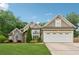 Charming home boasts a manicured lawn, classic architectural details, and a welcoming two-car garage at 1020 Regency Dr, Acworth, GA 30102