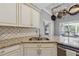 Close-up of kitchen featuring granite countertops, stainless steel appliances, and tile backsplash at 1020 Regency Dr, Acworth, GA 30102
