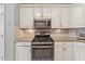 Kitchen with stainless appliances, granite countertop, and white cabinets at 1020 Regency Dr, Acworth, GA 30102