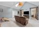 This living room has a vaulted ceiling, a ceiling fan, a skylight, access to the backyard and two other rooms at 1020 Regency Dr, Acworth, GA 30102