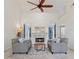 Bright living room with high ceilings, modern ceiling fan, fireplace and elegant furnishings at 1020 Regency Dr, Acworth, GA 30102