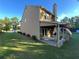Side view of the backyard featuring covered patio, spacious lawn and mature trees at 1430 Lily Valley Dr, Lawrenceville, GA 30045