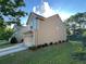 Side view of home with an attached two car garage and landscaping at 1430 Lily Valley Dr, Lawrenceville, GA 30045