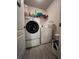Modern laundry room featuring front load washer and dryer, wire shelving, and ample storage at 1430 Lily Valley Dr, Lawrenceville, GA 30045