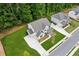 Aerial view of a suburban home showcasing its large lot, driveway, and proximity to lush greenery at 172 Aspen Hall Dr, Canton, GA 30115