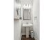 Half bathroom features a pedestal sink, decorative mirror, and white walls at 172 Aspen Hall Dr, Canton, GA 30115