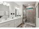 Modern bathroom with double vanity, tiled shower, and ample lighting at 172 Aspen Hall Dr, Canton, GA 30115