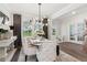 Bright dining room boasts modern chandelier and luxury chairs, creating an elegant space for entertaining and everyday meals at 172 Aspen Hall Dr, Canton, GA 30115