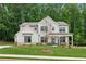 Beautiful two-story home with covered front porch, green lawn, and elegant landscaping at 172 Aspen Hall Dr, Canton, GA 30115