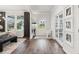 Inviting foyer with hardwood floors, abundant natural light, and stylish decor with direct access to dining room at 172 Aspen Hall Dr, Canton, GA 30115