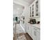 Bright, modern kitchen with white cabinetry, stainless steel appliances, and hardwood floors at 172 Aspen Hall Dr, Canton, GA 30115