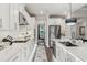 Modern kitchen features white cabinetry, stainless steel appliances, and a well-lit layout for seamless cooking and entertaining experience at 172 Aspen Hall Dr, Canton, GA 30115