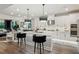 Modern kitchen with white cabinets, quartz countertops, and a center island with bar seating, perfect for entertaining guests at 172 Aspen Hall Dr, Canton, GA 30115