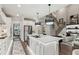 Bright, open kitchen with large island, white cabinetry, and modern appliances, steps away from the open living and dining areas at 172 Aspen Hall Dr, Canton, GA 30115