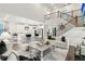 Bright, open-concept living space with a modern staircase, soaring ceilings, and a view into the kitchen at 172 Aspen Hall Dr, Canton, GA 30115