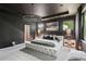 Stunning main bedroom boasts a tufted platform bed, chandelier, and scenic backyard views at 172 Aspen Hall Dr, Canton, GA 30115