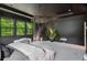 View of the main bedroom featuring a tufted platform bed, chandelier, and backyard at 172 Aspen Hall Dr, Canton, GA 30115