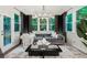 Bright sunroom featuring a cozy couch, plush rug, and large windows with lush greenery view at 172 Aspen Hall Dr, Canton, GA 30115