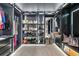 Expansive walk-in closet featuring custom shelving, cabinets, and hanging racks at 172 Aspen Hall Dr, Canton, GA 30115